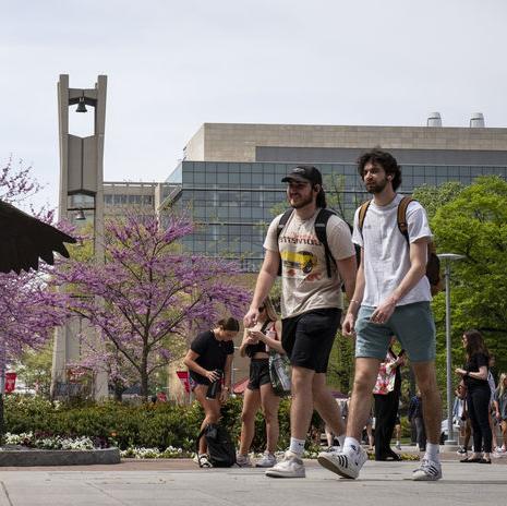 students walk across Main Campus on a spring day.